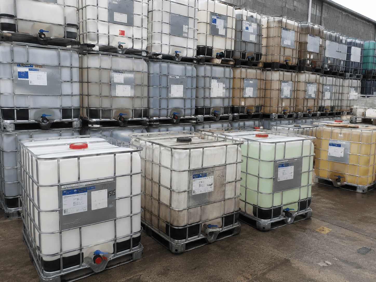 Multi-grade used IBC totes in the intake area at IBC Illinois.